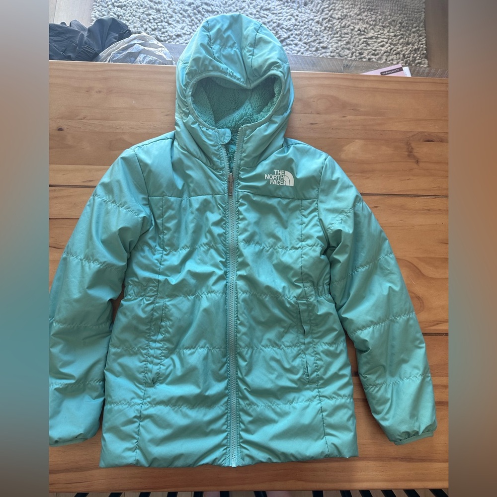 The North Face Kids' Teal reversible winter coat.